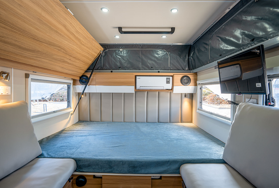 HQ12 main bed with seating and side windows