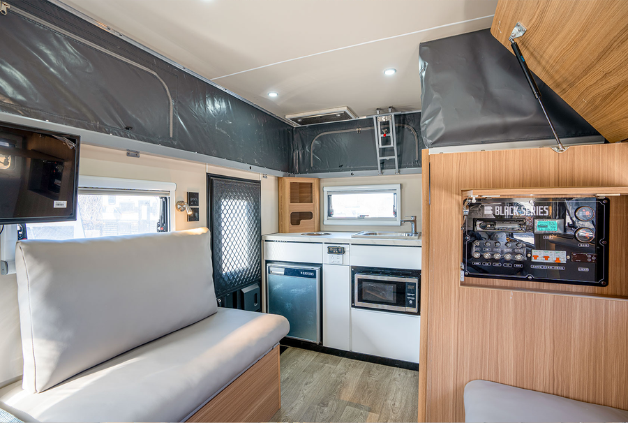 HQ12 interior showing kitchen, lounge and sleeping layout