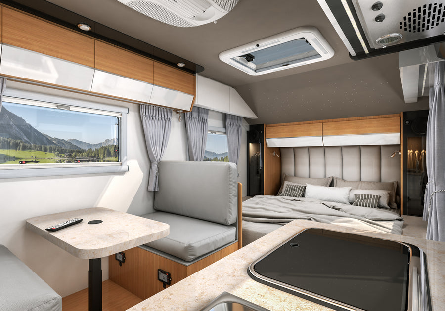 HQ15 main bed beside dinette seating and kitchen counter