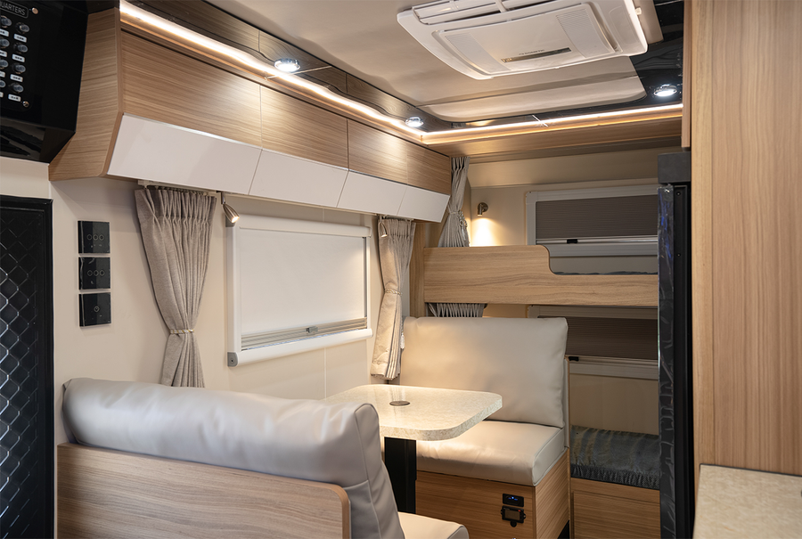 HQ17 dinette with overhead cabinetry and rear bunk beds