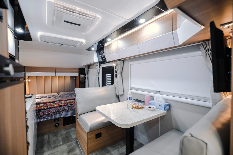 HQ19 lounge seating, dining table, overhead storage and bedroom