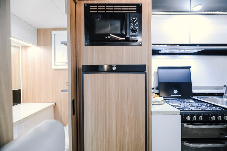 HQ19 refrigerator and microwave beside the indoor kitchen