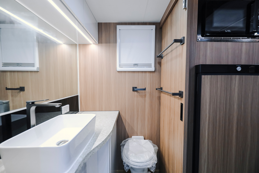 HQ19 bathroom with vanity, toilet, window and towel rails