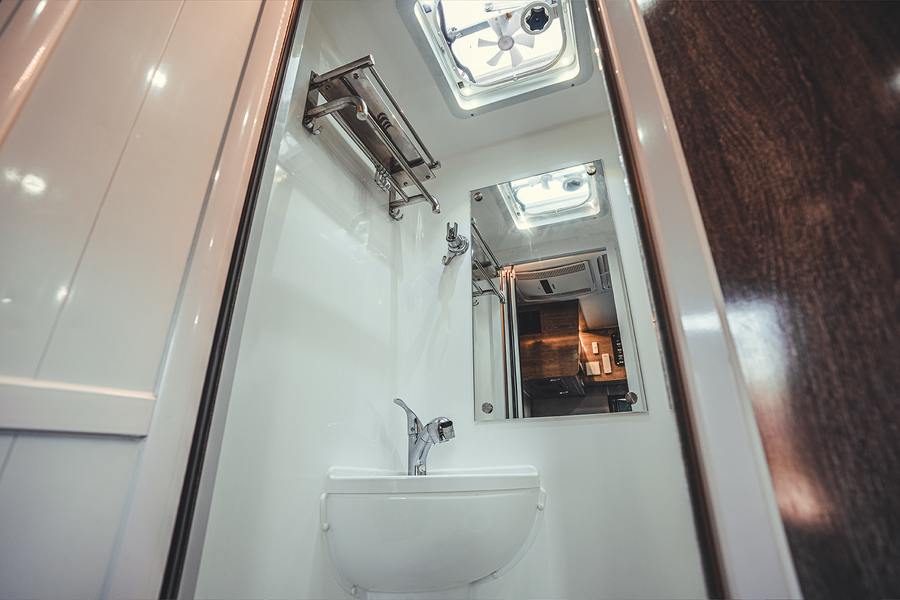 TH-series bathroom with toilet, shower fittings, ventilation and overhead storage